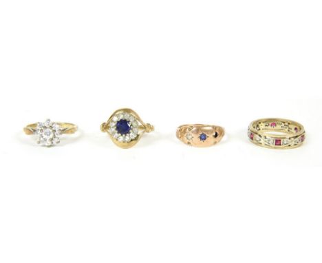 A 9ct gold three stone ring, ( stone deficient ), a 9ct gold synthetic ruby and synthetic spinel full eternity ring, 7.92g, a