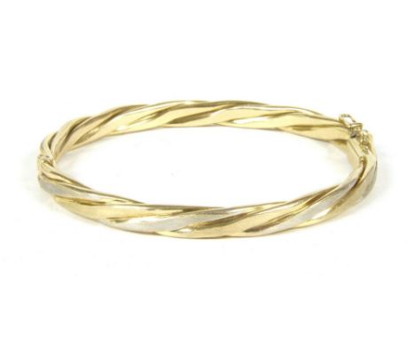 A 9ct two colour gold twisted design hinge bangle, with concealed box link clasp, 18.30g