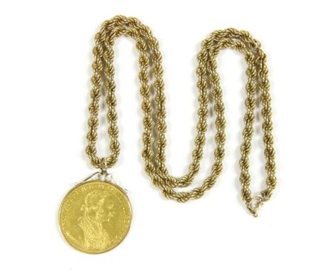 A 1915 Austrian 4 Ducat Restrike coin, channel set to a scroll top pendant, mount suspended on a hollow rope link chain (dama