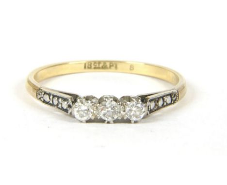 A gold three stone diamond ring, marked 18ct PLAT, 2.15g