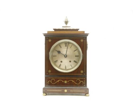 A Regency style Rosewood and brass 'inlaid' bracket clock, the pineapple finial over silvered dial, with black roman numerals