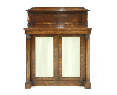 A Regency rosewood chiffonier, with a shelf over turned columns, a plain frieze over a cupboard with pleated green panels, 99