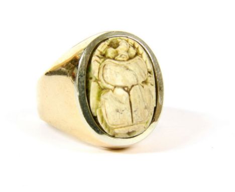 An Italian gold ring, set with a scarab beetle, full drilled, faced in white to the bezel, tested and valued as 18ct, 7.09g