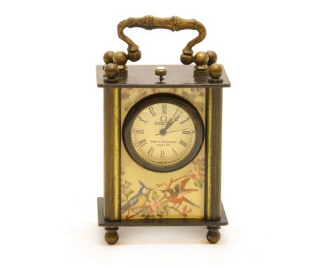 A miniature carriage clock, the dial marked 'Omega, Made in Switzerland, since 775', with classical panels, height 75cm
