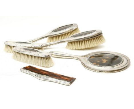 A silver and tortoiseshell six piece dressing table set, comprising four brushes, comb and mirror