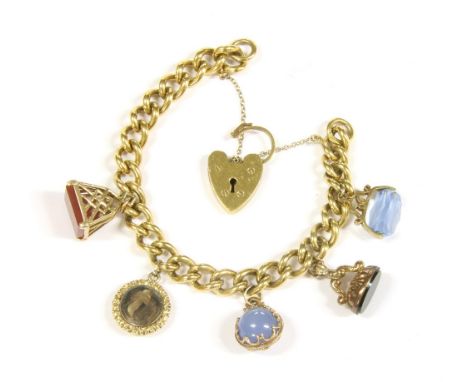 A gold plated curb link bracelet with rolled gold padlock, and three 9ct gold charms, a gold cased locket, and a rolled gold 