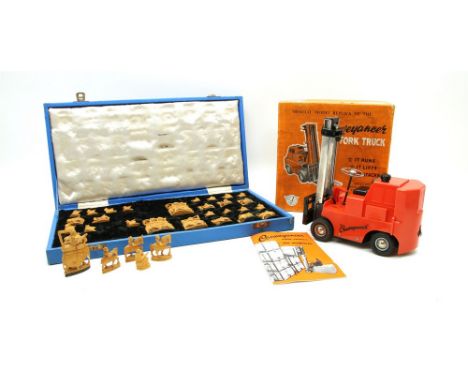 A cased set of Indian chess pieces with elephants etc in a boxwood, together with a Conveyancer Fork Truck model in original 