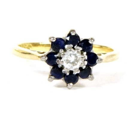 A diamond and sapphire daisy cluster ring, with chenier shoulders and a plain polished shank, 3.79g, size L