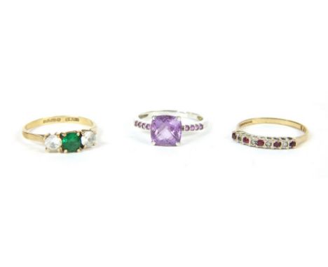 A 9ct gold three stone green and white paste stone ring, 1.70g, a 9ct gold ruby and diamond half eternity ring, 1.30g, and a 