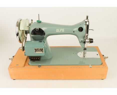 A vintage 1960s electric sewing machine by Alfa of Spain &ndash; with &lsquo;Sew-Tric Ltd&rsquo; motor, on a beech wood plint
