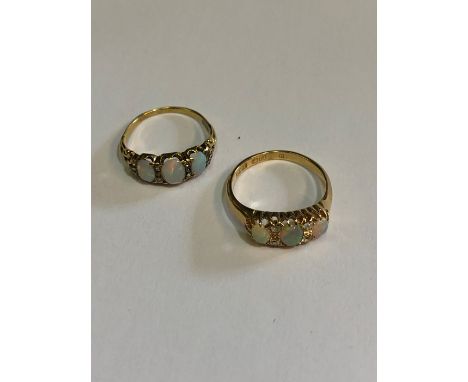 An antique 18ct yellow gold ring set with three graduated oval opals and four old cut diamonds, size R to/w a similar three s