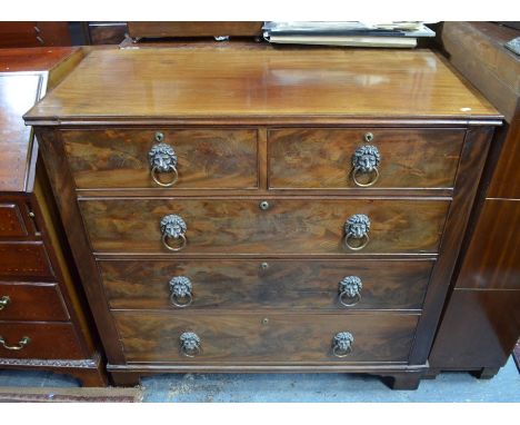 A George III mahogany chest of two short over three graduated drawers, with (later) brass lion ring handles, on shaped bracke