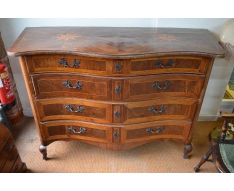 A North European 18th century inlaid walnut commode chest, probably Maltese, of serpentine form, the top with two large inlai