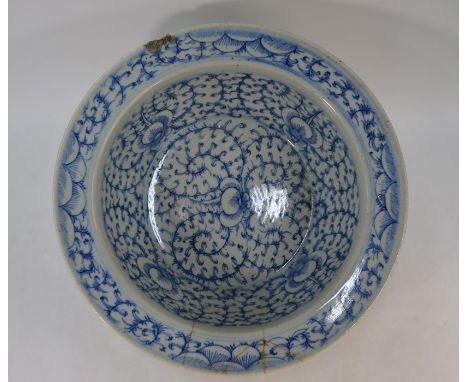 A large Chinese 18th century blue and white bowl with a wide everted rim, the interior painted in underglaze blue with lotus 