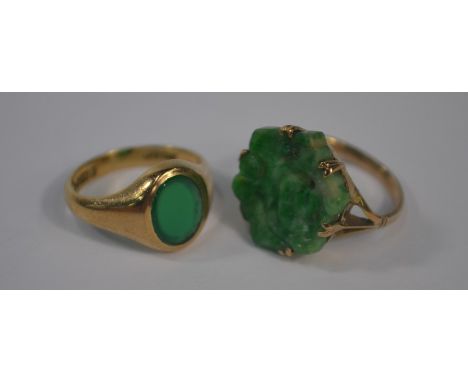 A carved green jade ring set yellow metal, size H to/w oval green stone signet ring (vacant), 9ct yellow gold set, size I (2)