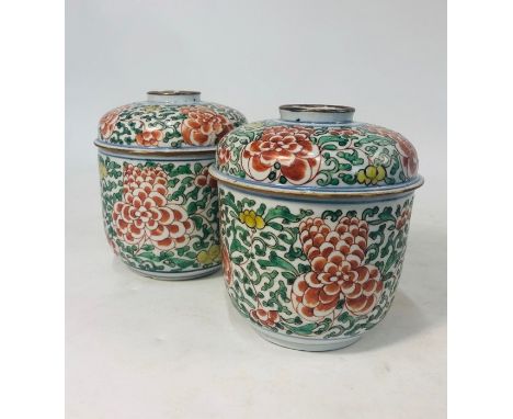 A pair of 19th century Chinese porcelain wucai decorated jars and covers, painted in underglaze blue and polychrome enamels w
