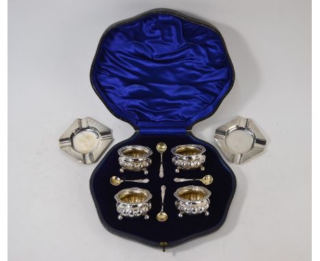 An Edwardian cased set of four silver open salts of lobed form with foliate rims and ball feet, William Hutton &amp; Sons Ltd