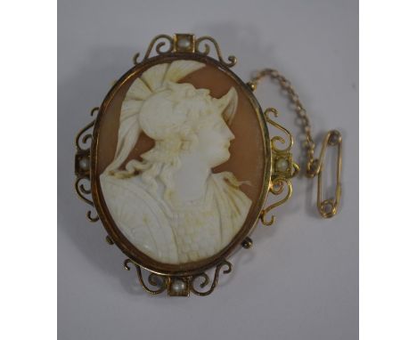 A Victorian oval shell cameo brooch featuring the well-carved profile portrait of Mars, in scroll rope work yellow gold mount