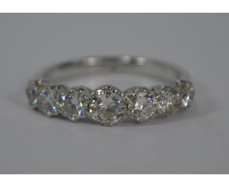 A seven stone graduated half eternity ring set circular diamonds, white metal set (unmarked and untested), size O, approx 3.8