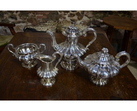 A William IV/Victorian four-piece tea/coffee service of lobed form on stemmed foot, with lily-flower finials, Charles Fox, Lo