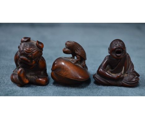 Three Japanese Meiji period (1868-1912) carved wooden netsuke; Kappa the water imp, caught by a clam trying to release his tr