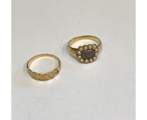 A 19th century yellow gold mourning ring with plaited hairwork panel surrounded by seed pearls, inscribed within and dated 18