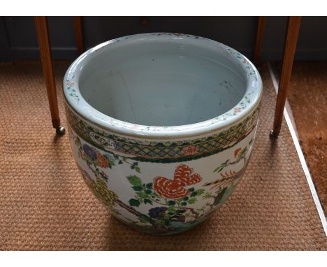 A 19th century Chinese ceramic famille vert jardiniere painted in polychrome enamels with exotic birds perched amongst fruiti