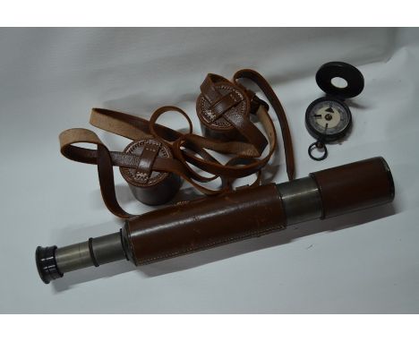 A leather bound two-draw telescope 56cm overall, with leather sleeve and end-cap, to/w a lacquered brass bearing compass (2)