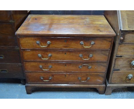 A Georgian mahogany secretaire chest, the fitted top drawer over three long graduated drawers, raised on shaped bracket feet,