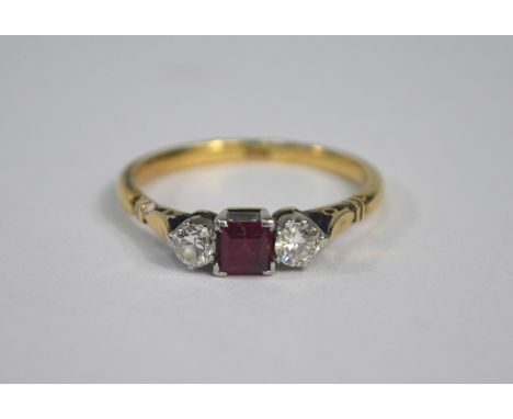 A three stone ring set yellow gold, the central square claw set ruby flanked by a circular diamond on each side, size O, appr