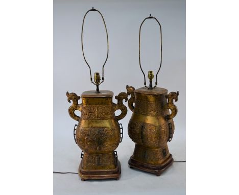 &nbsp;A pair of Chinese gilt brass Hu lamps in the form of ritual wine vessels, each with a pear-shaped body having shaped ha