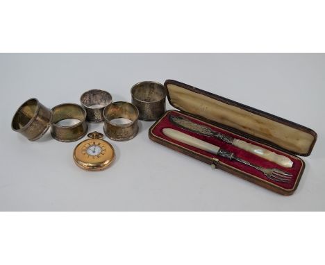 A Victorian cased silver butter knife and similar fork with carved mother-of-pearl handles, to/w four silver napkin rings, a 