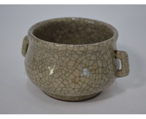 A Chinese Song style Ge ware ceramic censer of compressed circular form with loop handles, covered with an opaque pale grey g