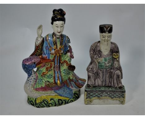 A Chinese 19th century ceramic famille rose female figure, probably Quanyin, seated wearing ceremonial dress holding a ruyi s