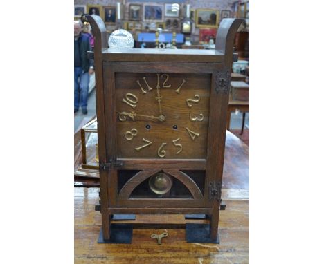 An Arts and Craft oak cased two train mantel clock with applied gilt Arabic numbers and gilt hands, over a pendulum window, 5