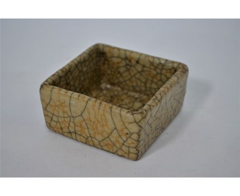 A Chinese Song style Ge ware ceramic brush washer of shallow square form, covered overall in an opaque pale greyish glaze suf