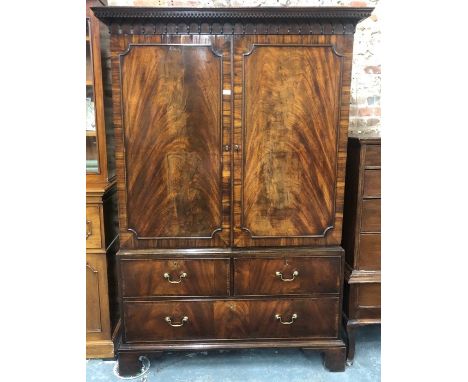 A George III flame mahogany linen cabinet, the dentil moulded pediment over a pair of panelled doors enclosing two shelves, o