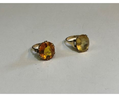 A 9ct yellow gold ring set with orange oval citrine, size R&nbsp; to/w a similar yellow oval citrine set with yellow metal, s