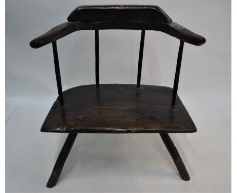 An 18th century style vernacular yoke-back chair, with four stick back over a single piece seat on four rough turned stick le