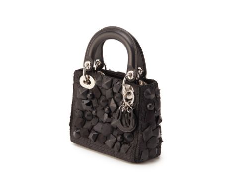 From a private Singaporean collection
Black leather Mini Lady Dior, Embellished, with authenticity card and designer charm
Ch