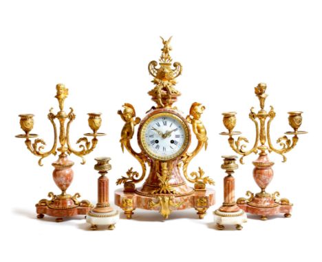 A French pink breccia marble and ormolu mounted clock garniture in Louis XVI style, the eight day brass drum movement, with a