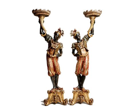 A pair of Italian Venetian carved pine and polychrome decorated blackamoor torchères, with silvered and gilt highlights, each