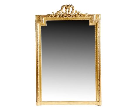 A French giltwood and composition overmantel mirror in Louis XVI style, with a shaped rectangular plate, within a beaded slip