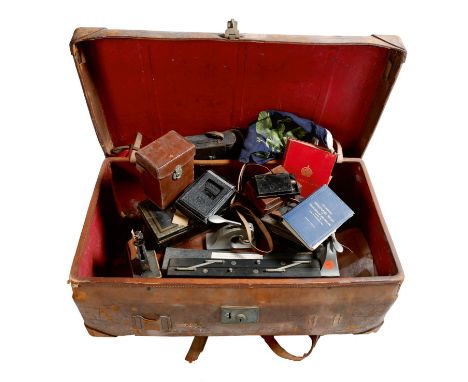 A late Victorian brown leather travelling trunk, applied with old labels, the lid inscribed 'LORD TERENCE BROWNE', containing