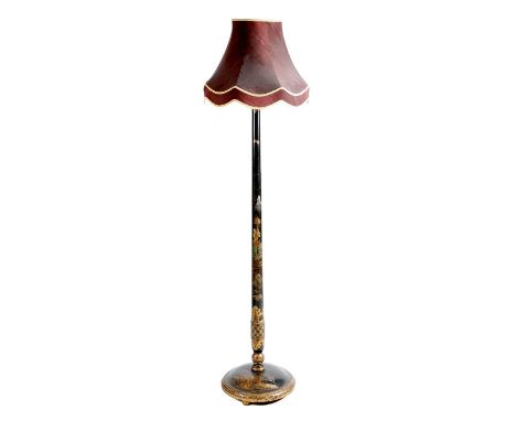 A black japanned standard lamp, decorated in gilt with chinoiserie, with a circular base, early 20th century, fitted for elec