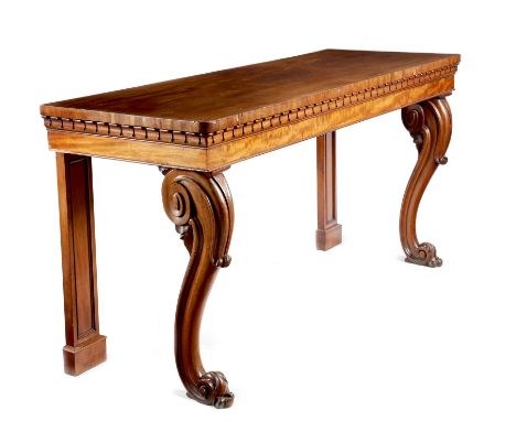 An early Victorian mahogany serving table, with a lappet frieze above scroll carved cabriole front legs and panelled back leg