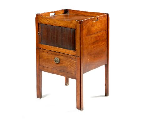 A George III mahogany tray-top bedside commode, the gallery pierced with a pair of handgrips above a tambour shutter and a co