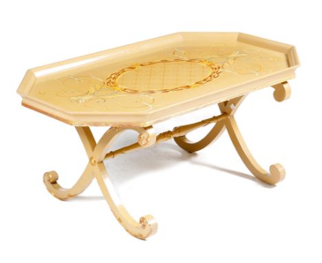 A modern painted coffee table by Thomas Messel, with parcel gilt decoration, the tray-top painted with leaf scrolls and a cen