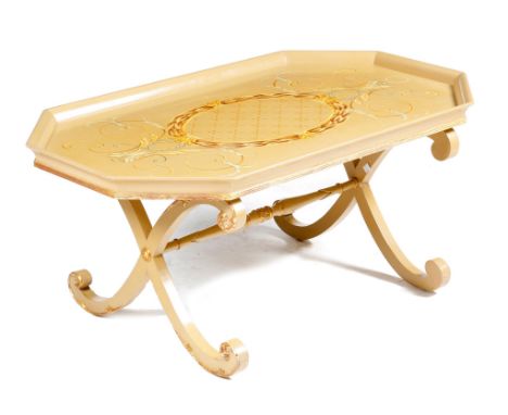 A modern painted coffee table by Thomas Messel, with parcel gilt decoration, the tray-top painted with leaf scrolls and a cen