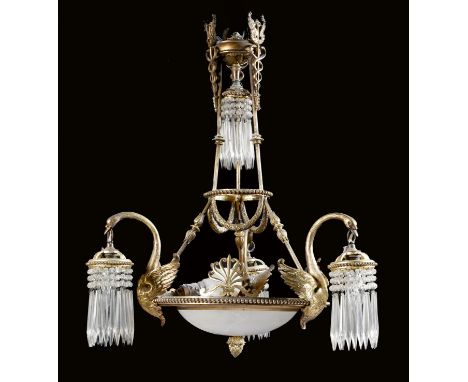 An Empire style gilt brass six-light chandelier, decorated with caducei, palmettes and with swan branches and hung with cut g